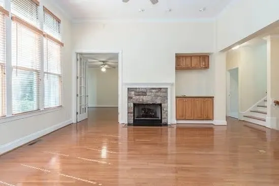 Open living room with fireplace and hardwood flooring
