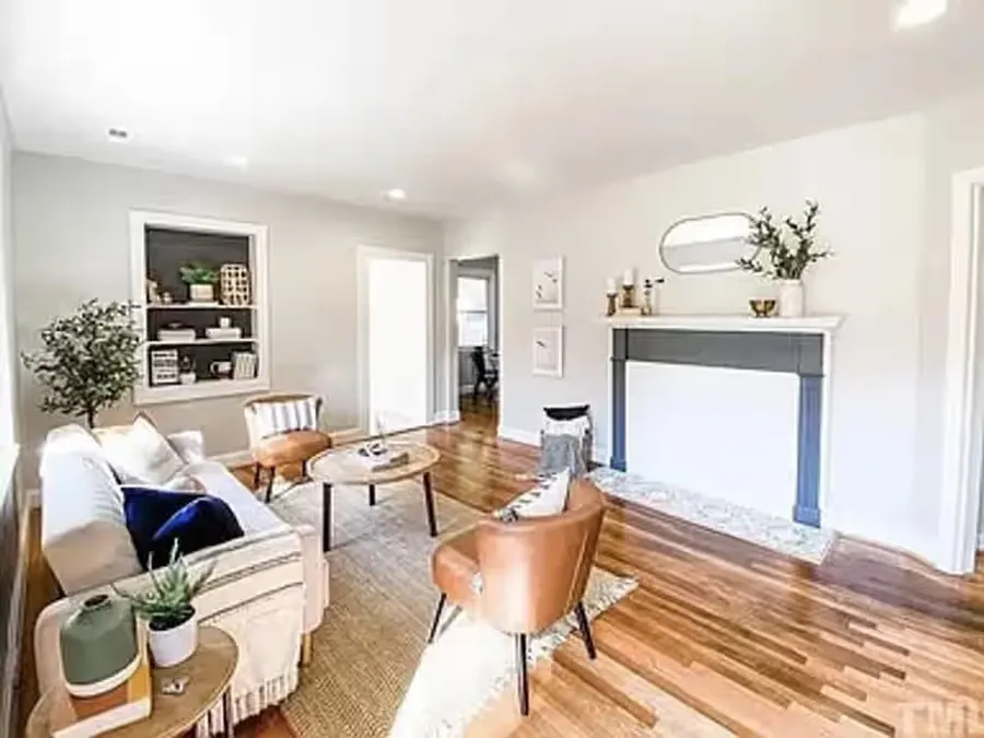 Bright renovated living room with fireplace and sitting area
