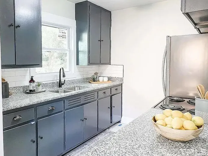 Custom kitchen renovation with blue island and white cabinetry